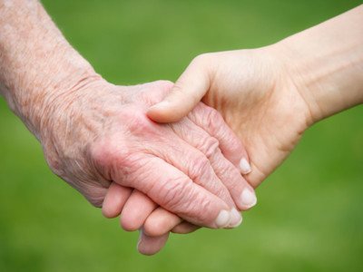 Senior and Young Women Holding Hands